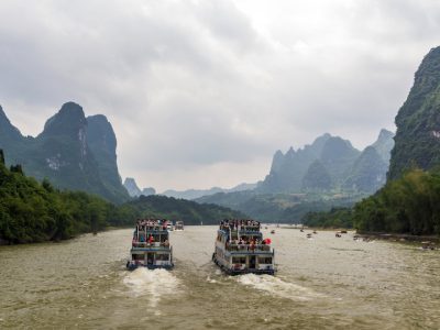 Cruise ship packed with tourists travels the magnificent scenic route along the Li river from Guilin to Yangshou.